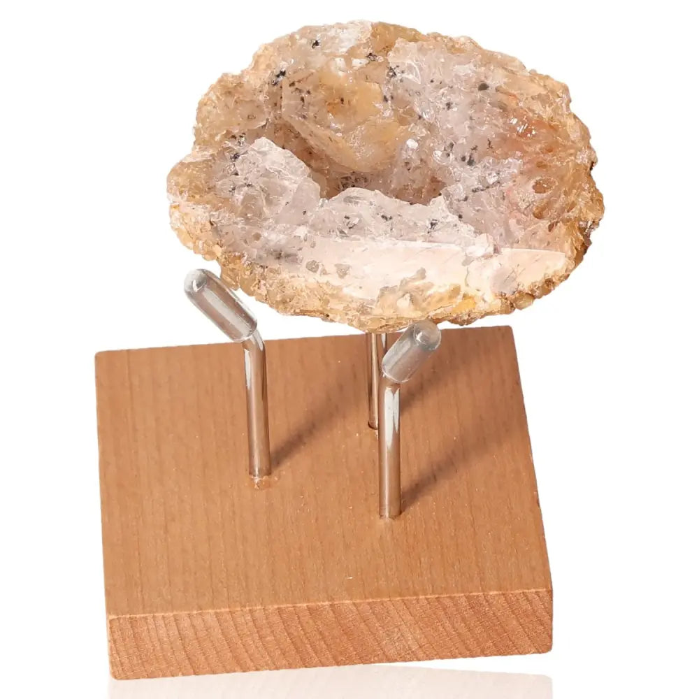 Mini Agate Geode displayed on a wooden stand, showcasing its rich textures and natural patterns as a symbol of balance and serenity.