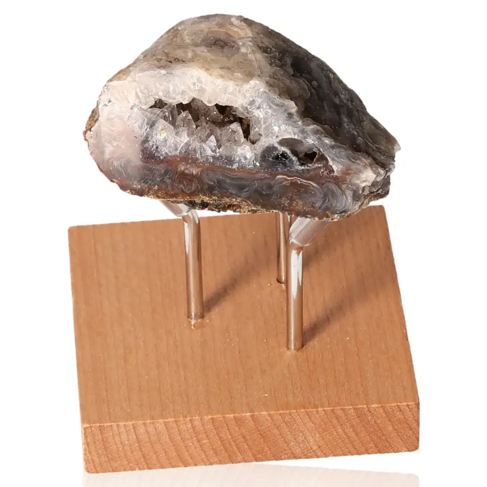 Mini Agate Geode on a wooden stand, showcasing its intricate natural design and serene beauty, perfect for harmonizing any space.