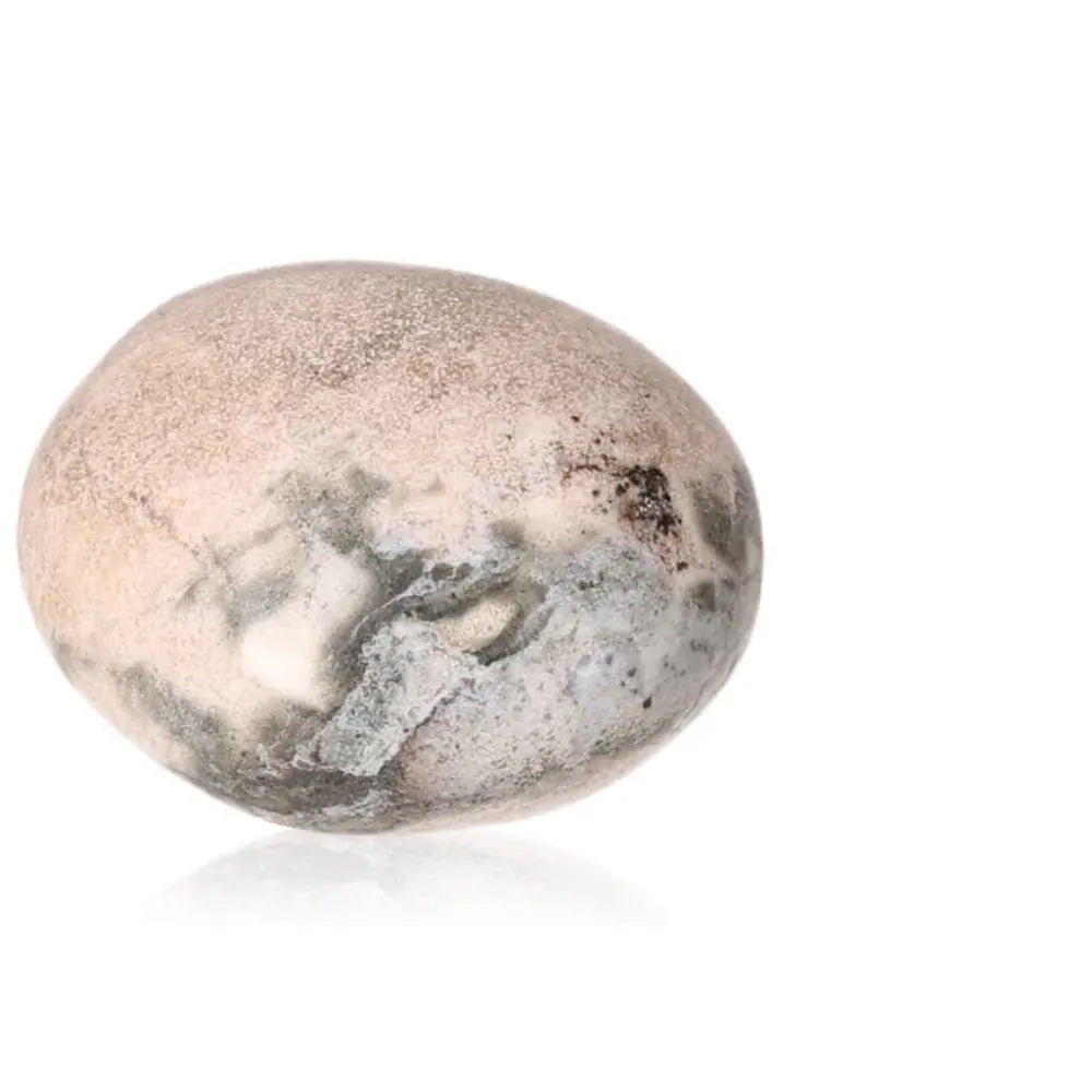 Tumbled Jasper stone featuring calming hues, promoting stress relief and vitality-enhancing properties in a serene setting.