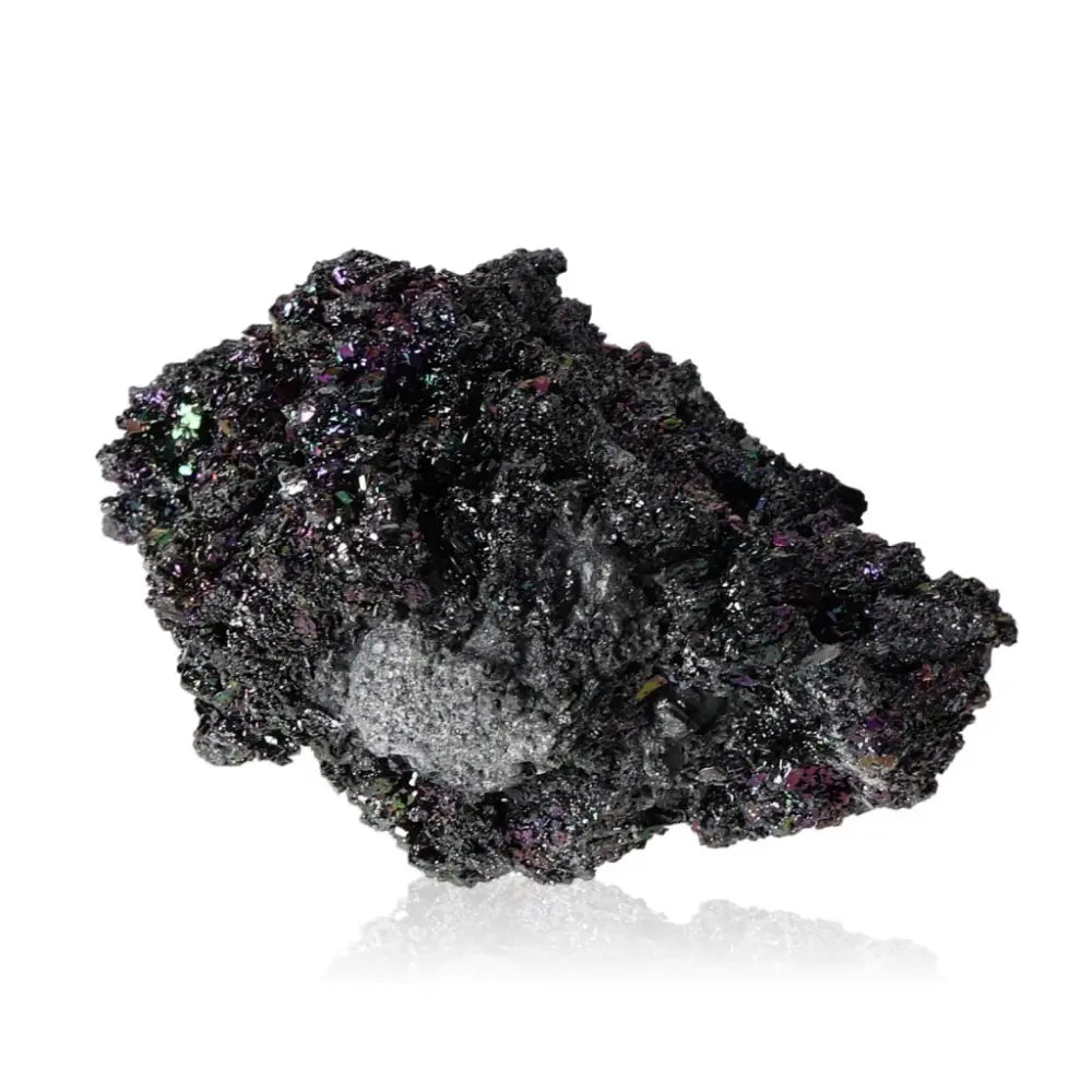 Carborundite stone displaying a shimmering rainbow-like surface, known for energy amplification and transformation properties.