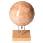 Peach Moonstone Sphere on display stand, showcasing its emotional balance and protection against nightmares.