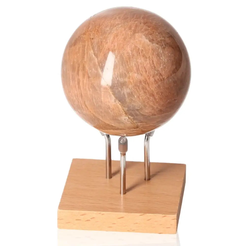 Peach Moonstone Sphere on stand, enhances emotional balance and intuition, aids women’s attractiveness, protective against nightmares.