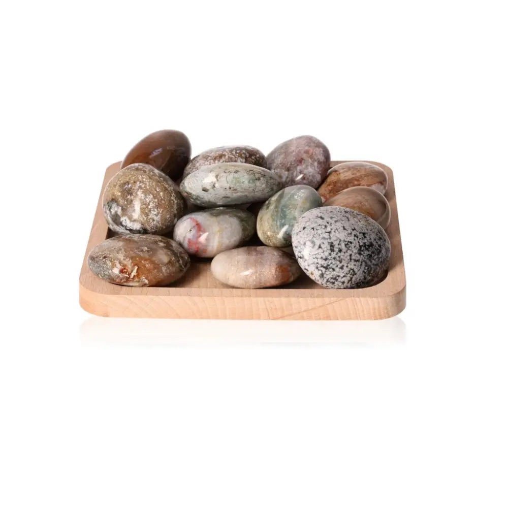 Ocean Jasper Palm Stones XL arranged on a wooden tray, known for spiritual depth and positive energy, promoting tranquility and harmony.