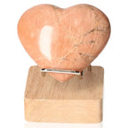 Peach Moonstone Heart on stand, enhances emotional balance and intuition, believed to protect against nightmares and ensure restful sleep.
