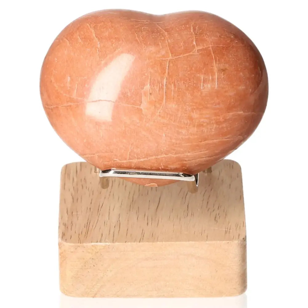 Peach Moonstone Heart highlighting sensitivity and emotional balance, stimulates intuition and protects against nightmares. Stand not included.
