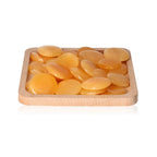 Orange Calcite Palm Stones on a wooden tray, enhancing self-confidence, motivation, and learning, ideal for energy and concentration boost.