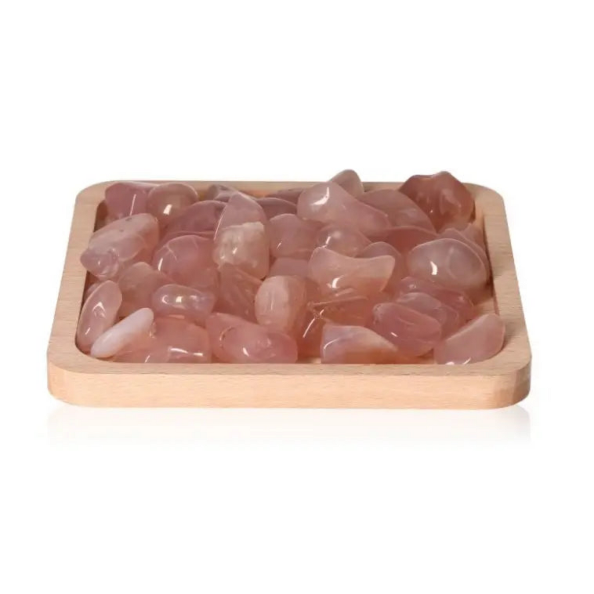 Pink Chalcedony crystals from Sylvia Crystals, promoting emotional balance and positive thinking, displayed on a wooden tray.