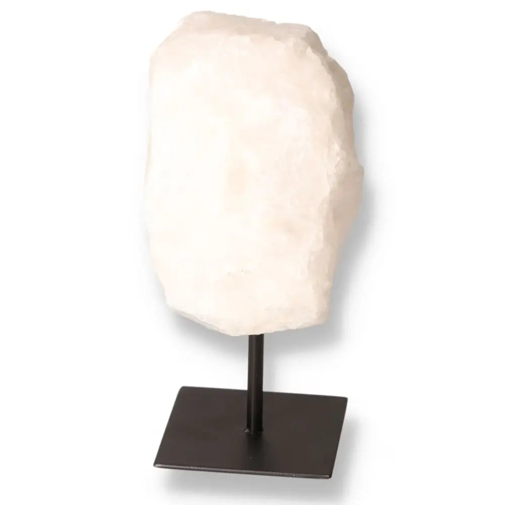 Cut Milky Quartz on metal stand, showcasing a serene, cloudy texture. Premium quality crystal from Sylvia Crystals, ideal for decoration and energy purification.