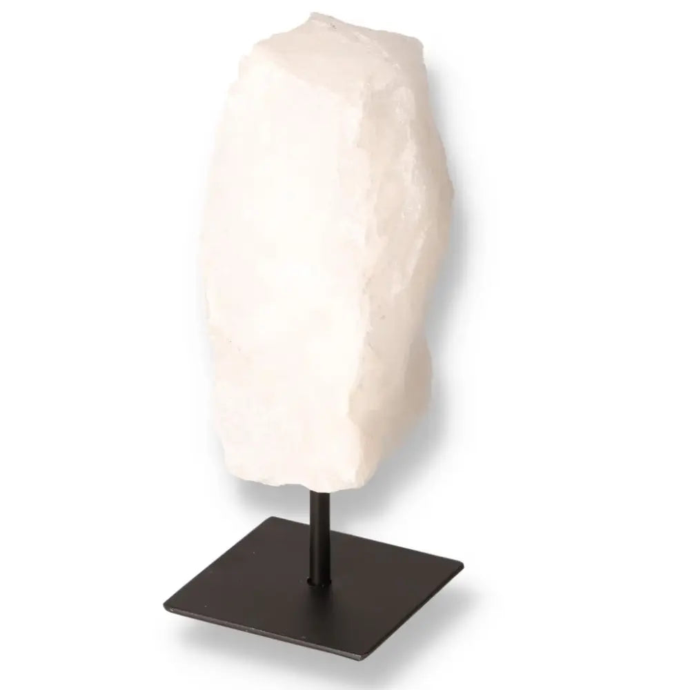 Milky quartz crystal on a sleek metal stand, showcasing its cloudy, serene beauty.
