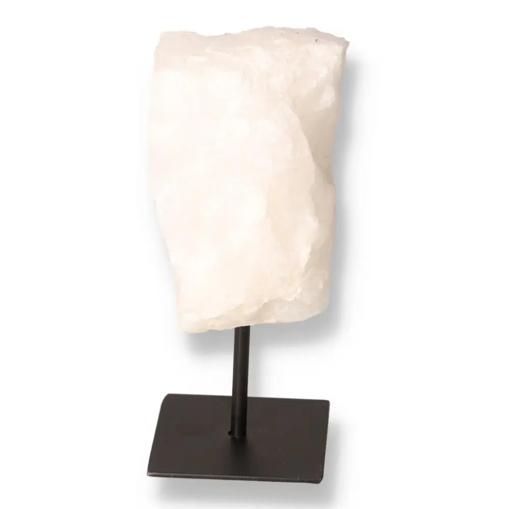 Cut Milky Quartz on a metal stand showcasing its opaque beauty, meticulously crafted by Sylvia Crystals, offering calming energy and elegance.