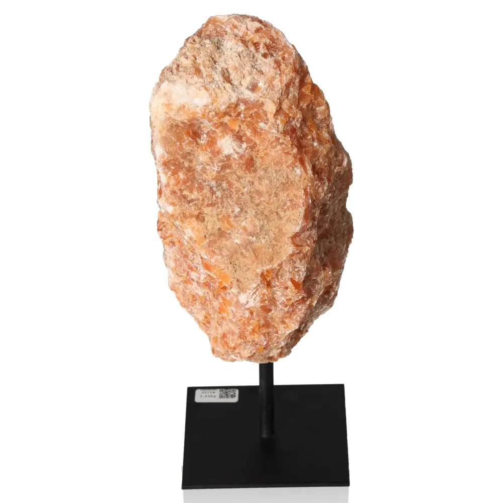 Orchid Calcite stone on metal stand, showcasing vibrant orange and soft pink tones, ideal for motivation and creativity enhancement.