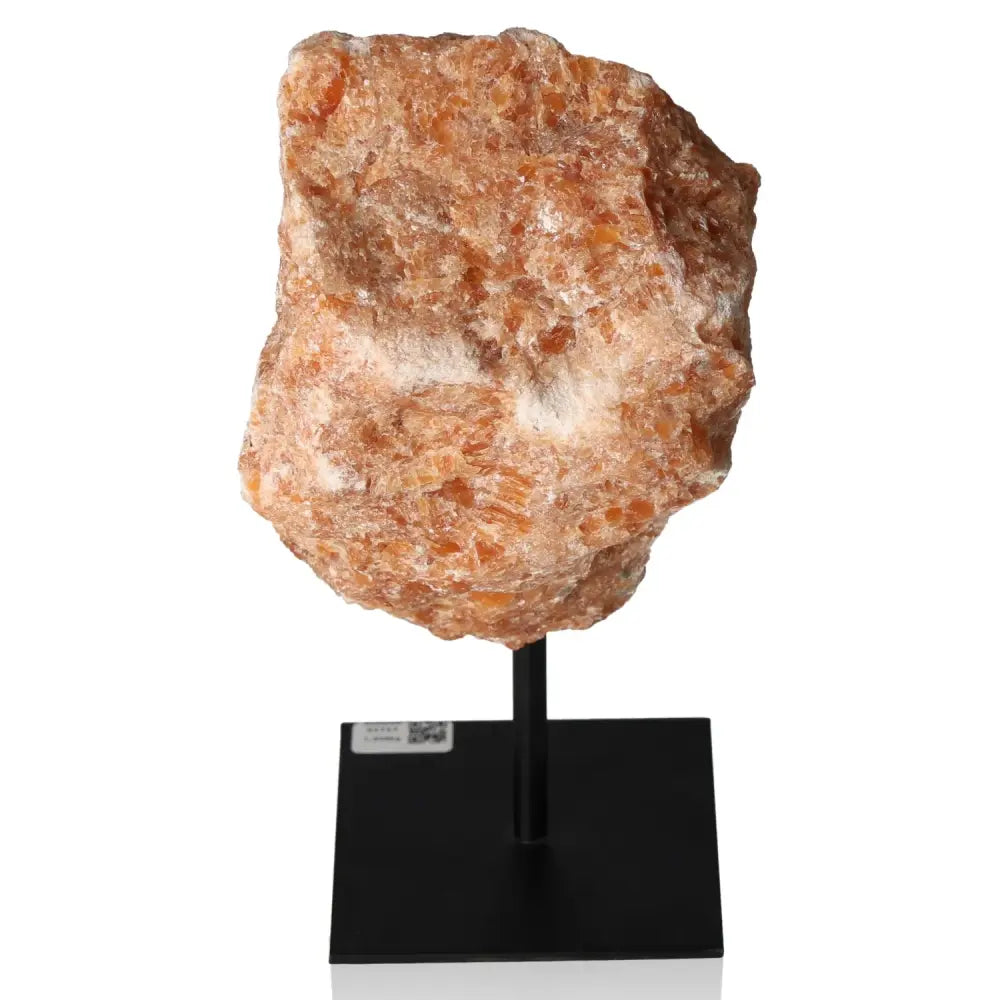 Orchid Calcite on metal stand, vibrant orange-pink gemstone symbolizing motivation, creativity, and emotional strength for personal growth.