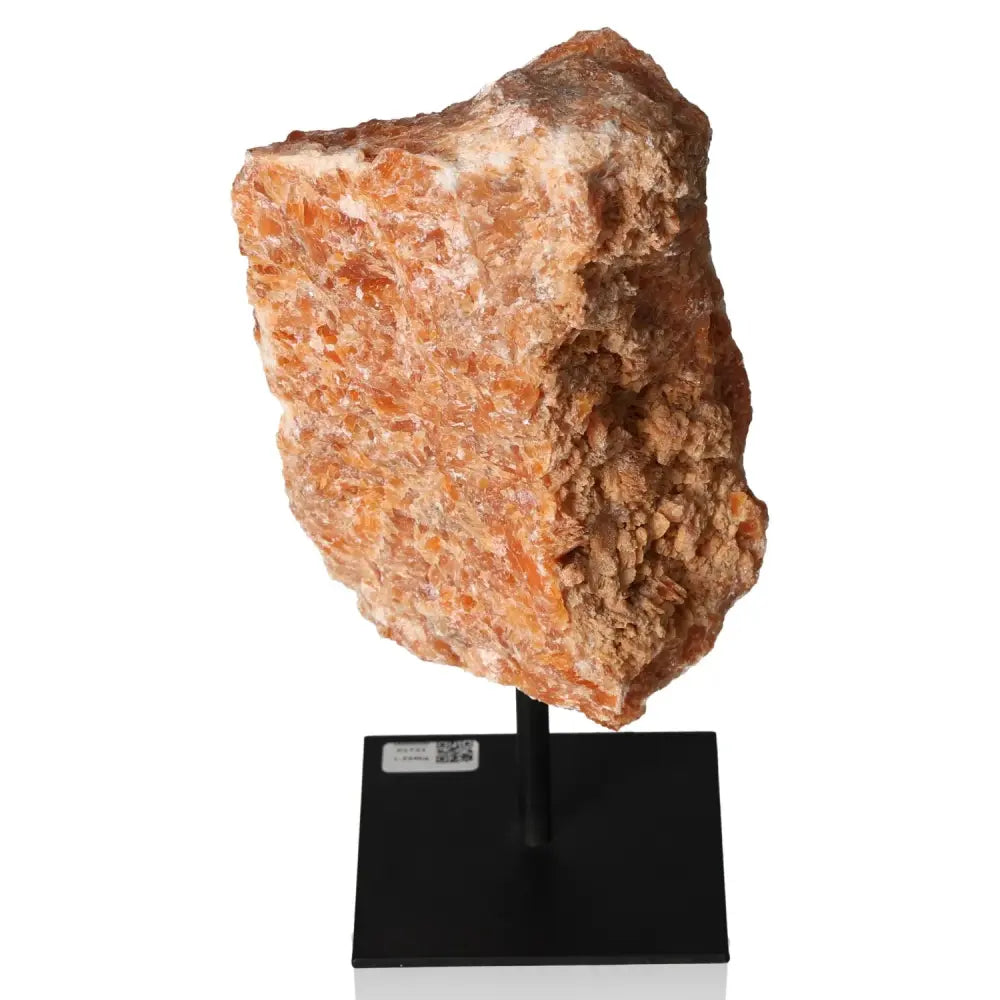 Orchid Calcite gemstone on metal stand, showcasing vibrant orange and soft pink tones for creativity and motivation enhancement.