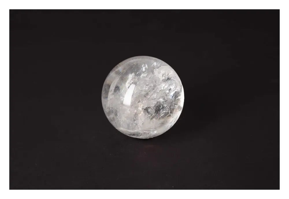 Lemurian Quartz Sphere by Sylvia Crystals, showcasing luxury and spiritual harmony on a sleek black background.