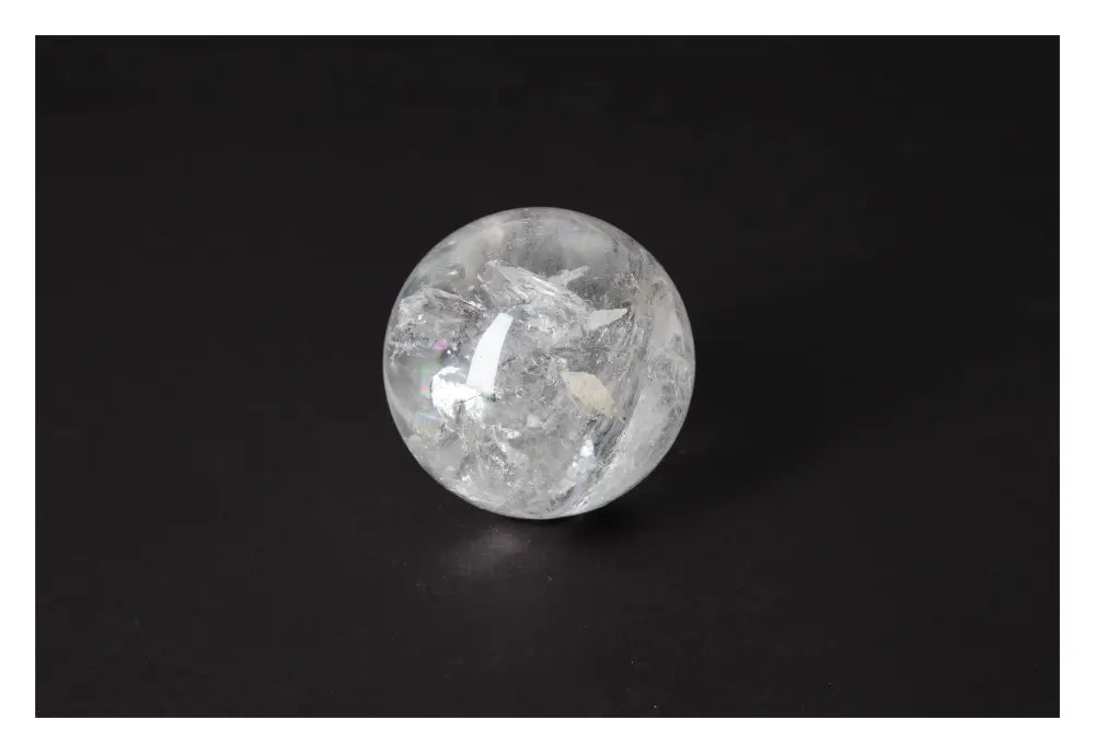 Lemurian Quartz Sphere by Sylvia Crystals on black background, showcasing its luxury and spiritual harmony.