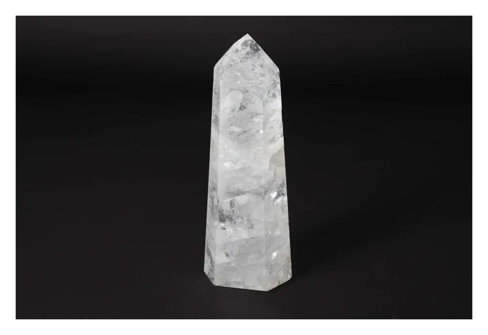 Clear Crystal Quartz Point from Sylvia Crystals, showcasing its elegance and spiritual harmony on a dark backdrop.