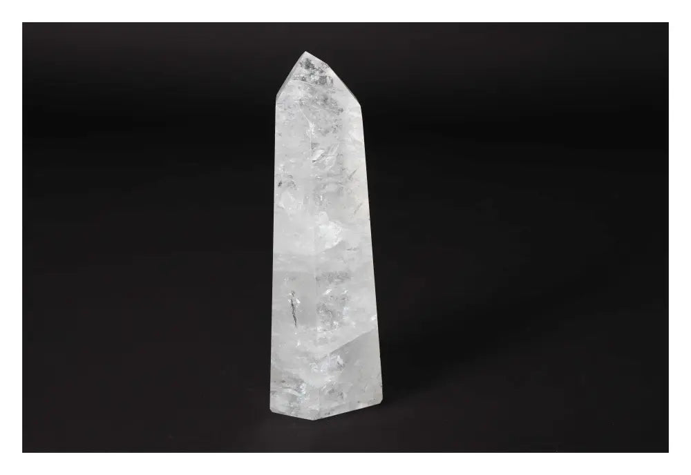 Clear Crystal Quartz Point from Sylvia Crystals displayed on a dark background, showcasing its natural beauty and spiritual elegance.