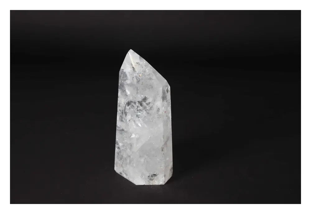 Clear Crystal Quartz Point on black background, offering clarity and spiritual growth; a premium Sylvia Crystals product.