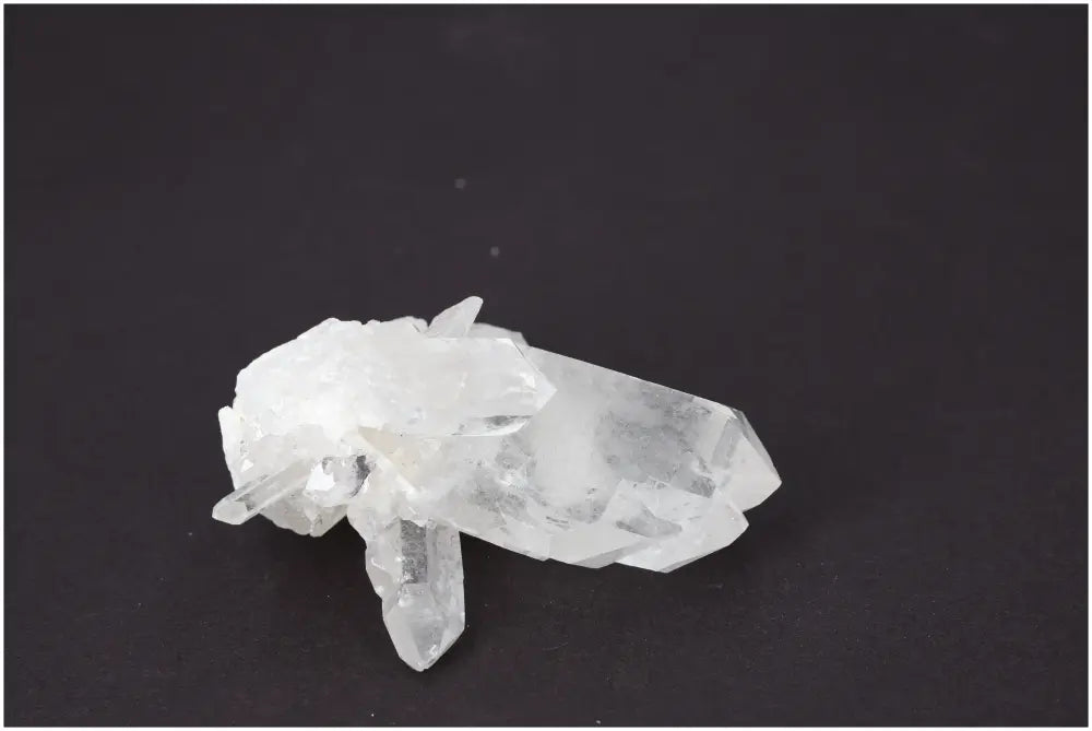 Rough Crystal Quartz Cluster on dark background, showcasing natural beauty and spiritual energy. Ideal for harmonizing environments.