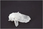 Rough Crystal Quartz Cluster on dark background, showcasing natural beauty and spiritual energy. Ideal for harmonizing environments.