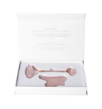 Open box of Rose Quartz Roller And Gua Sha Set 635356 showcasing the elegant pink facial tools inside.