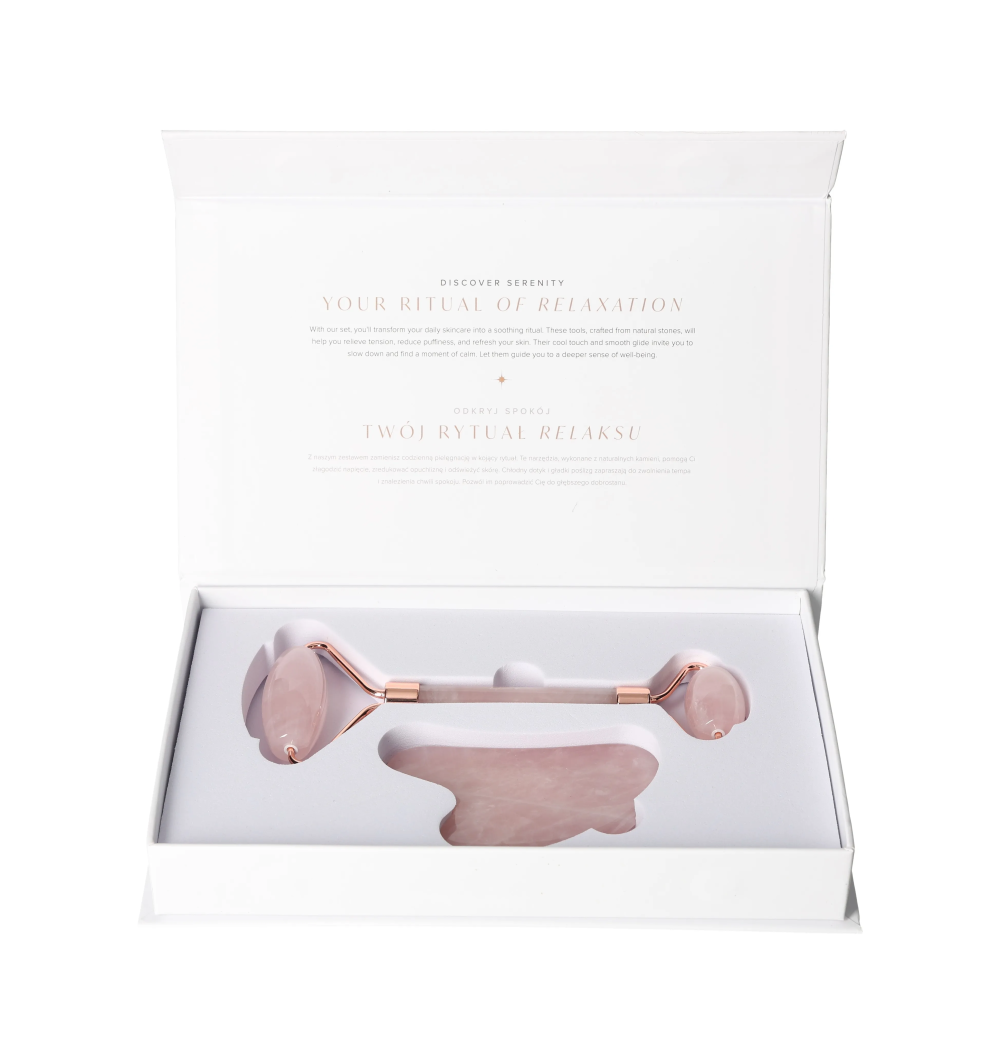 Open box of Rose Quartz Roller And Gua Sha Set 635356 showcasing the elegant pink facial tools inside.