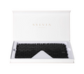 Obsidian Eye Mask 635387 in white SYLVIA CRYSTALS packaging, showcasing sleek black design for detoxification and revitalization.