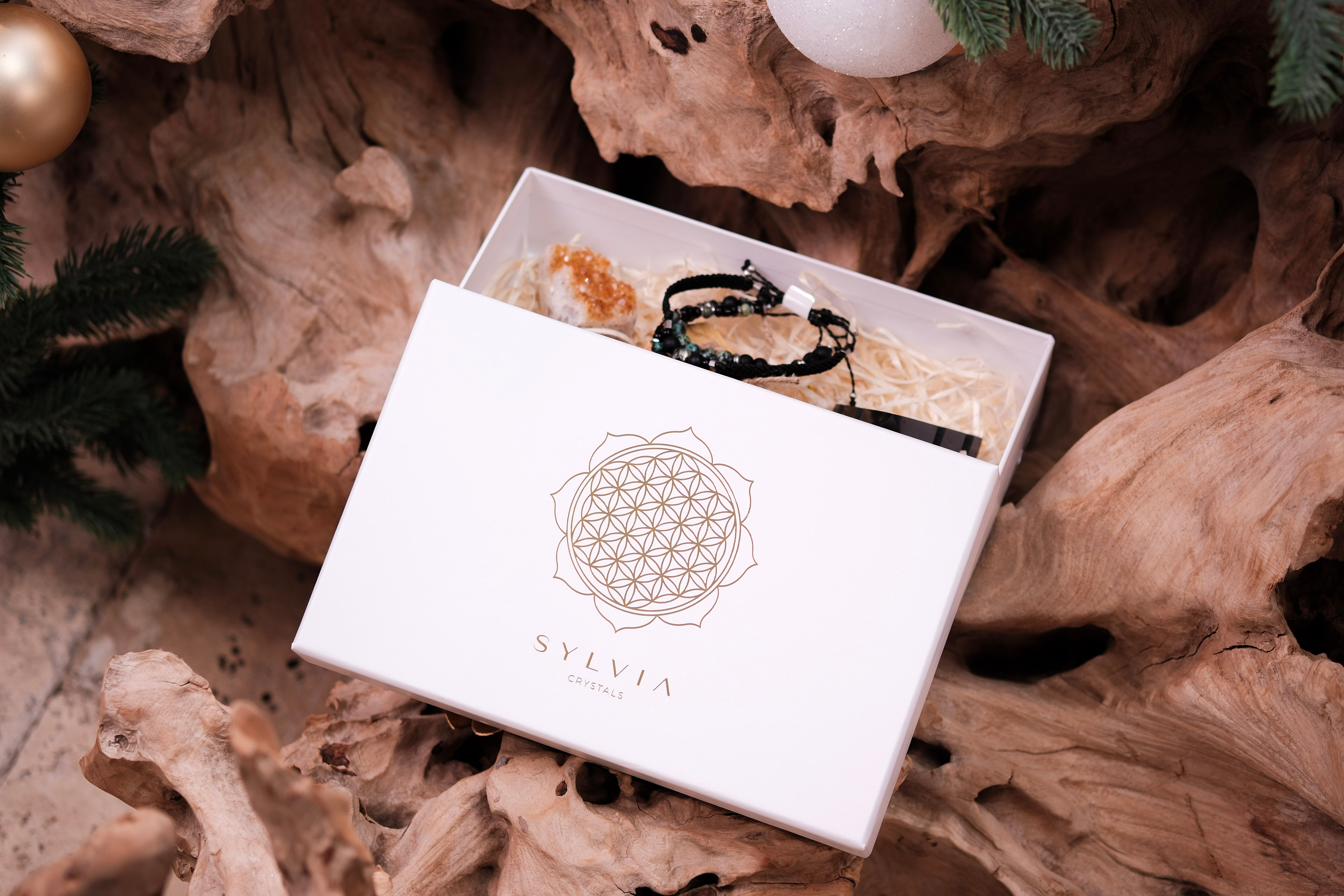 Christmas Luxury Crystal Gift Box with black shungite pyramid, elegant package on rustic background, perfect holiday gift.