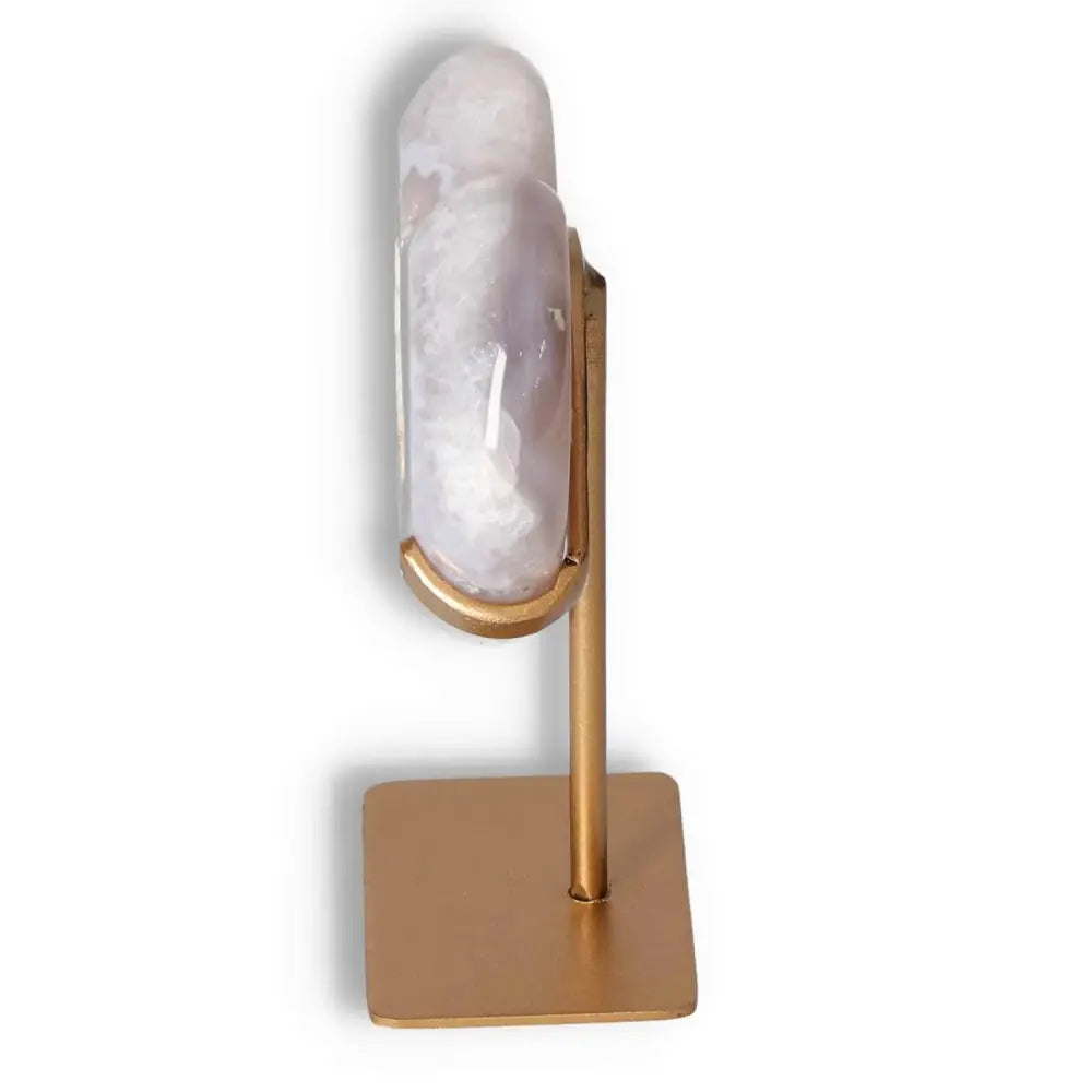 Side view of Sylvia Crystals' Agate Heart on a gold stand, showcasing its smooth texture and exquisite craftsmanship.