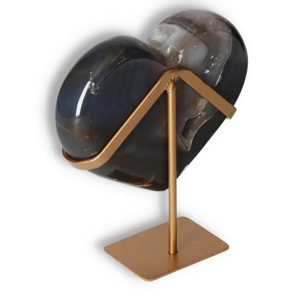 Polished agate heart with unique patterns on a stand, showcasing natural elegance and mesmerizing veining.