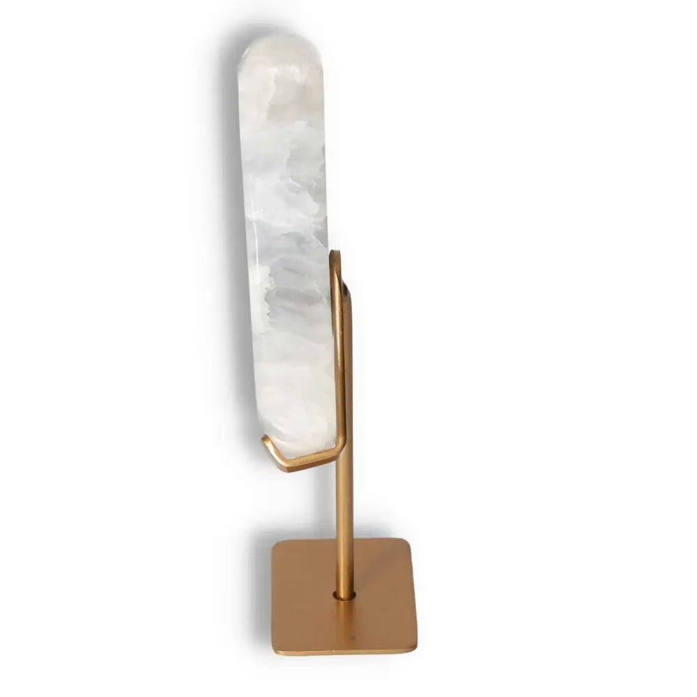 Agate lunar crescent on gold stand, showcasing translucent layers and natural geode formation, capturing celestial elegance and artistry.