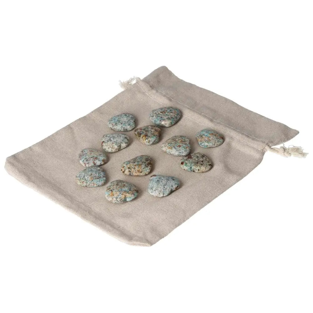Amazonite small heart stones for harmony and emotion balance on a beige pouch, promoting calm and security.