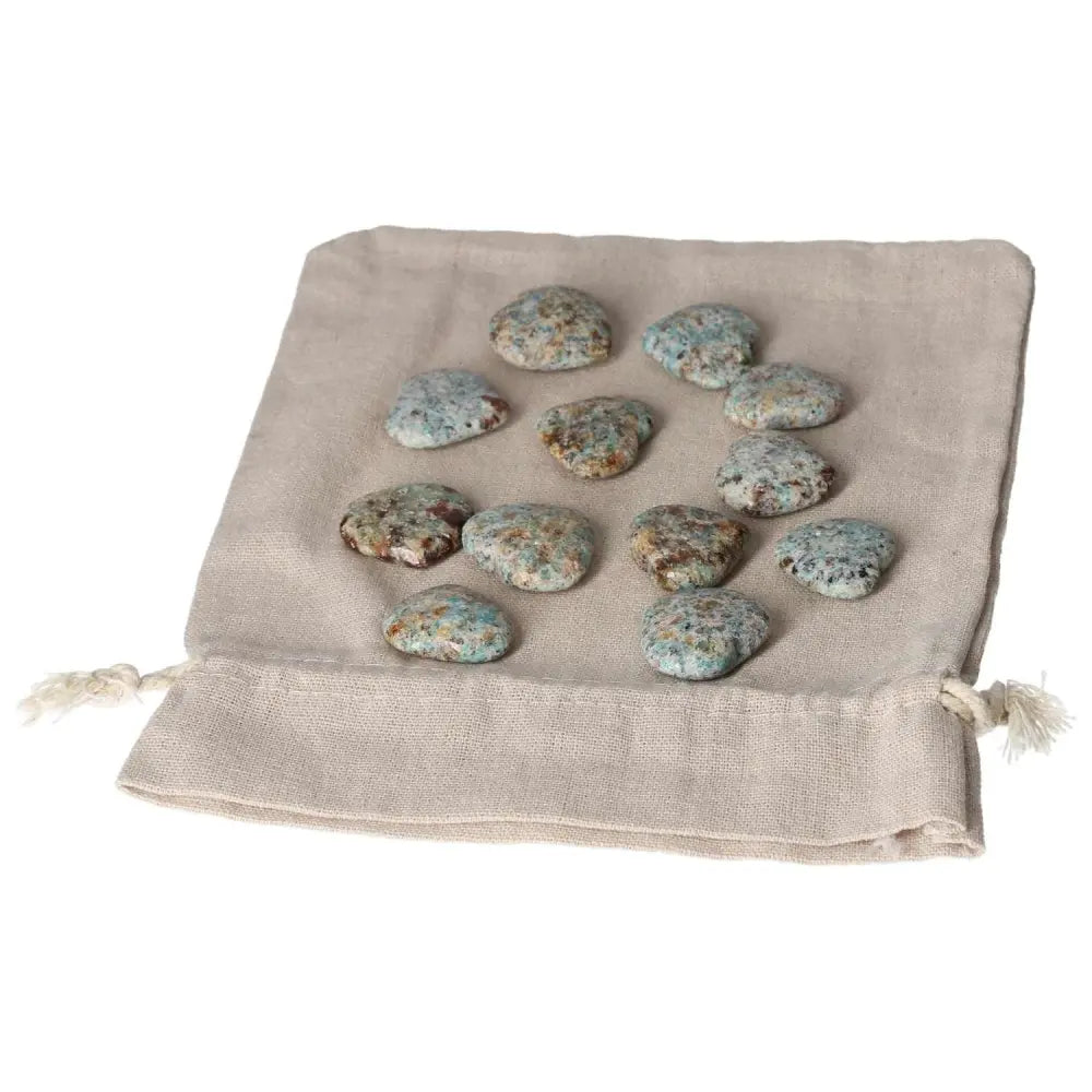 Amazonite small heart stones on beige pouch, promoting harmony and emotional balance, ideal for calming and security purposes.