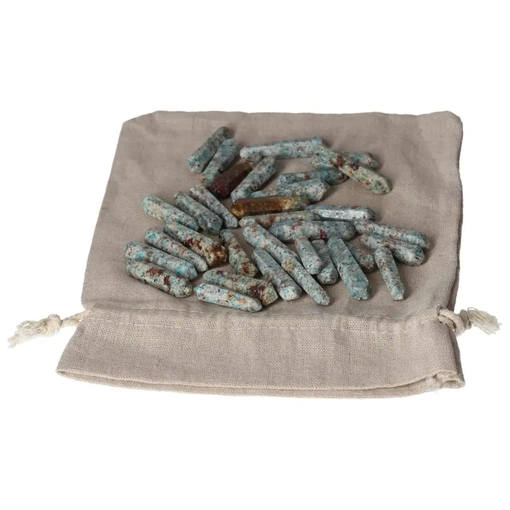 Amazonite small sticks on a beige cloth, ideal for emotional balance and calming, promoting harmony and security.