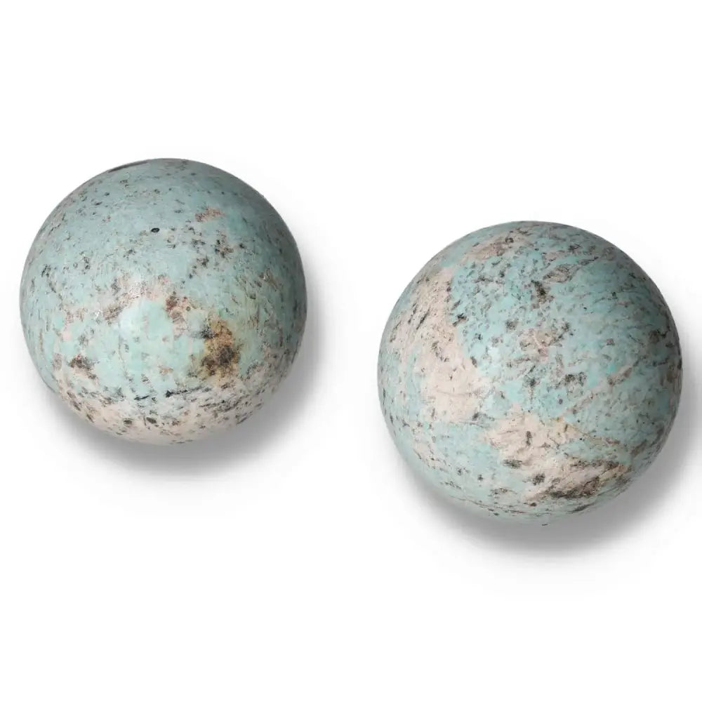 Amazonite gemstone spheres with soothing turquoise and green shades, promoting emotional balance and clear communication.