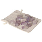 Amethyst stones on a beige cloth, ideal for stress relief and enhancing concentration.