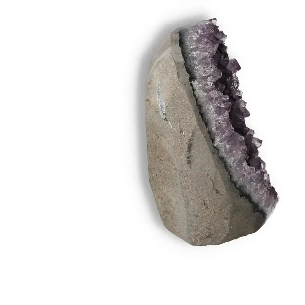 Amethyst Cut Base Geode with striking purple crystals from Sylvia Crystals, symbolizing luxury, elegance, and natural harmony.