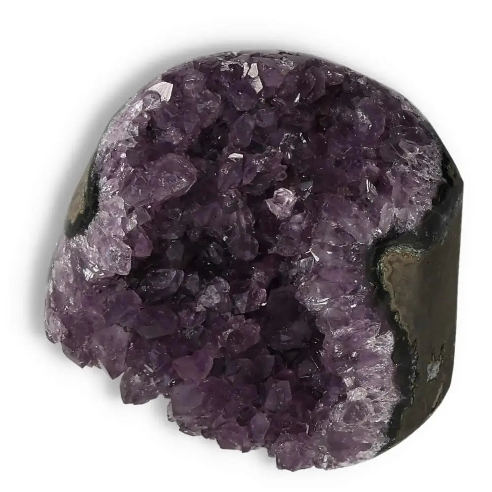 Amethyst Cut Base Geode from Sylvia Crystals on a white background, showcasing purple crystals and natural stone edges.
