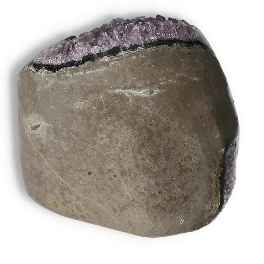 Side view of an Amethyst Cut Base Geode displaying raw purple crystals from Sylvia Crystals, ideal for stress relief and energy elevation.