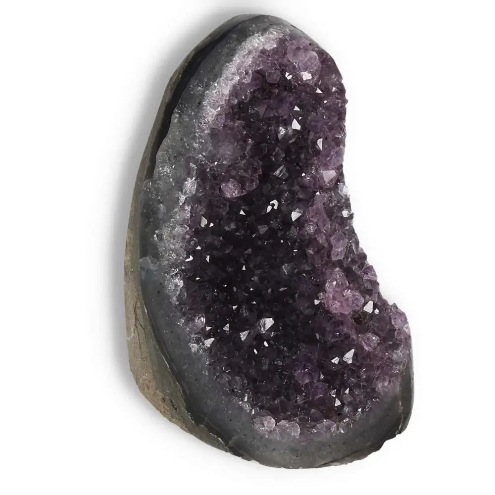 Amethyst Cut Base Geode showcasing deep purple crystals, perfect for adding luxury and spirituality to any space by Sylvia Crystals.