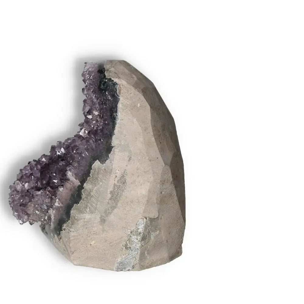 Amethyst Cut Base Geode from Sylvia Crystals, known for stress reduction and energetic boost, showcasing purple crystal interior.