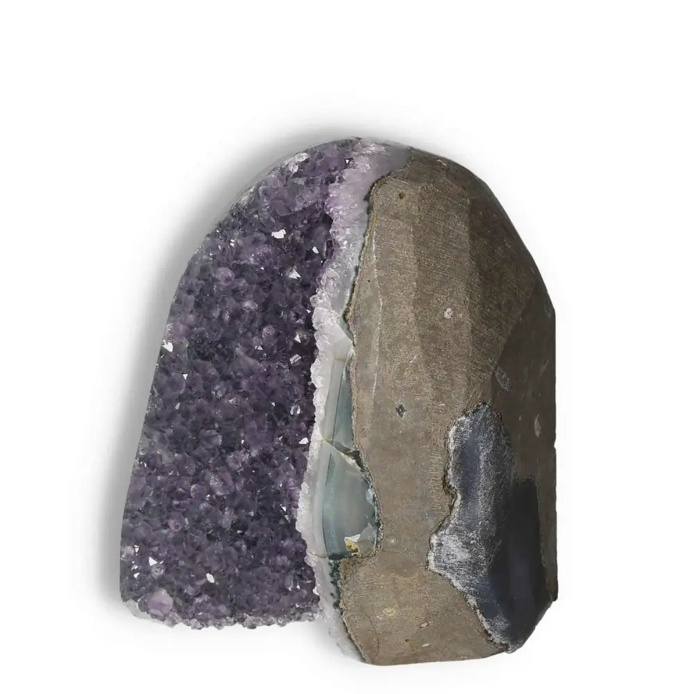 Amethyst Cut Base Geode showcasing luxurious purple crystals by Sylvia Crystals, epitomizing elegance and tranquility in modern design.