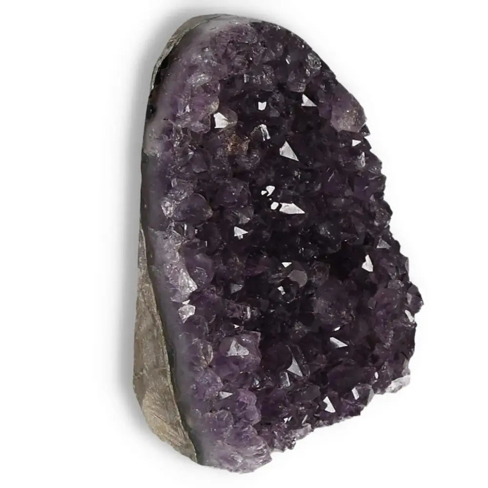 Amethyst Cut Base Geode by Sylvia Crystals, showcasing deep purple crystal formations, ideal for stress reduction and energy enhancement.