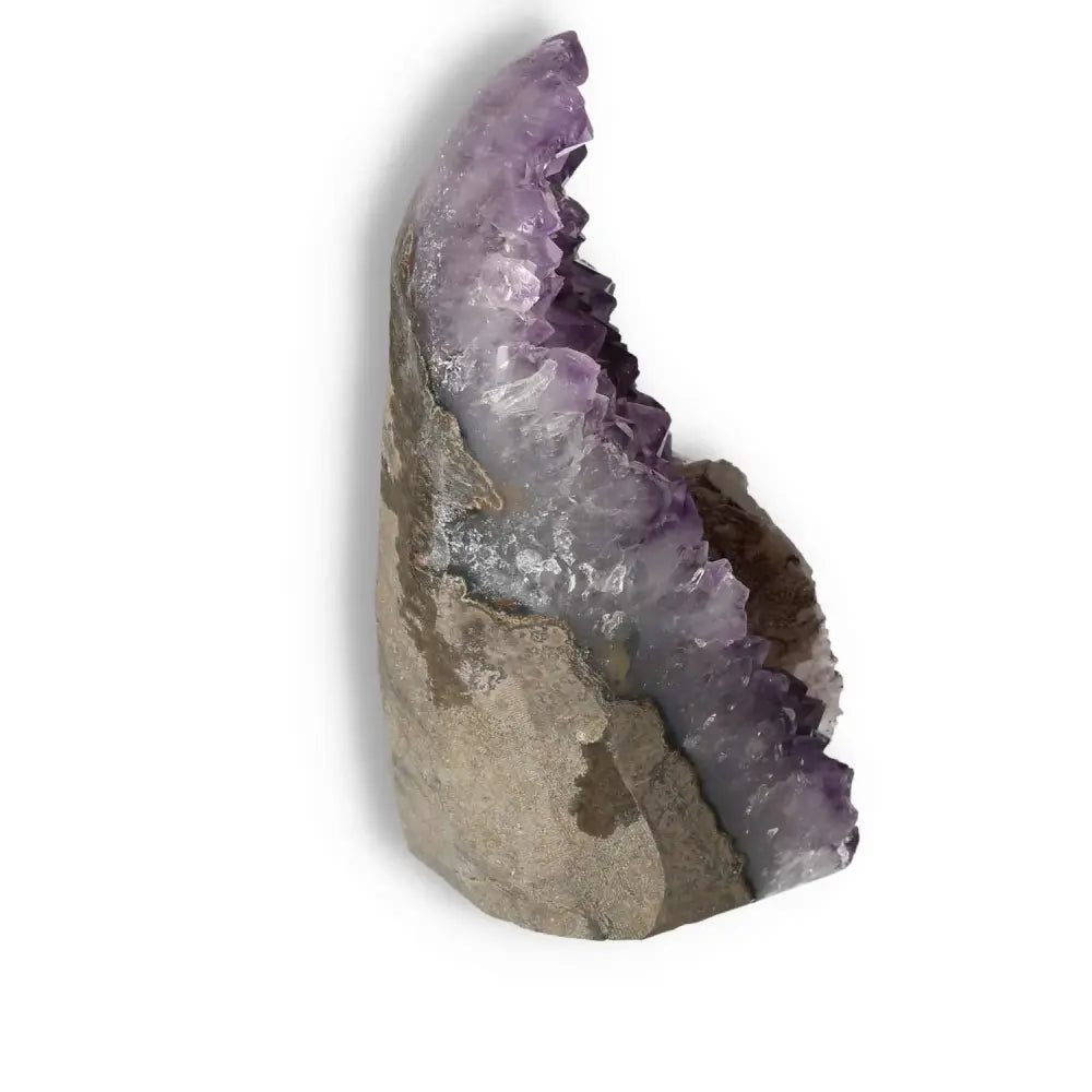Amethyst cut base geode by Sylvia Crystals, showcasing purple crystal formations, known for promoting tranquility and reducing stress.