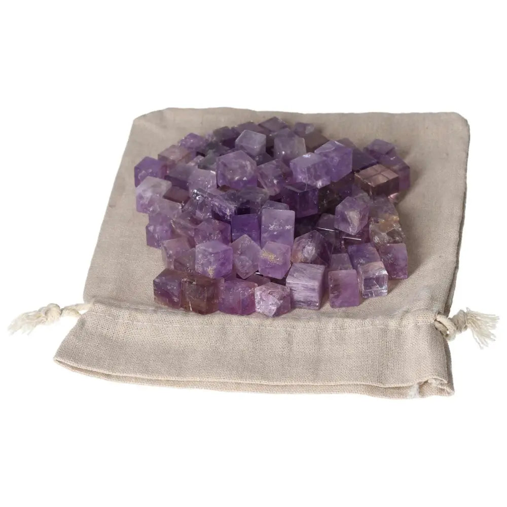 Amethyst small cubes on a fabric pouch, known for stress reduction, energy boosting, and enhancing concentration and emotional stability.