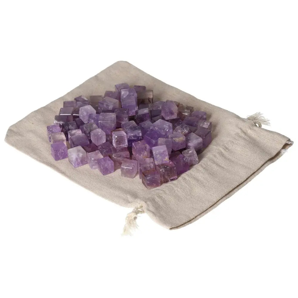 Amethyst small cubes on a cloth bag, known for stress reduction, energy boost, and emotional stability enhancement.