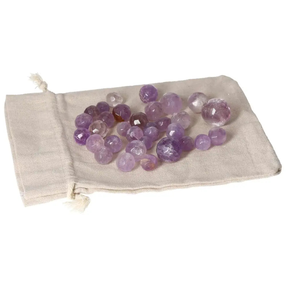 Amethyst small geometric spheres on a cloth bag, ideal for stress reduction, energy boost, enhanced concentration, and emotional stability.