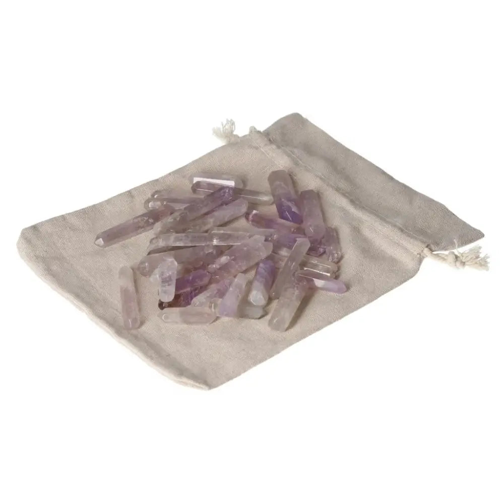 Amethyst small sticks on a drawstring pouch enhancing stress relief, energy boost, and emotional stability.