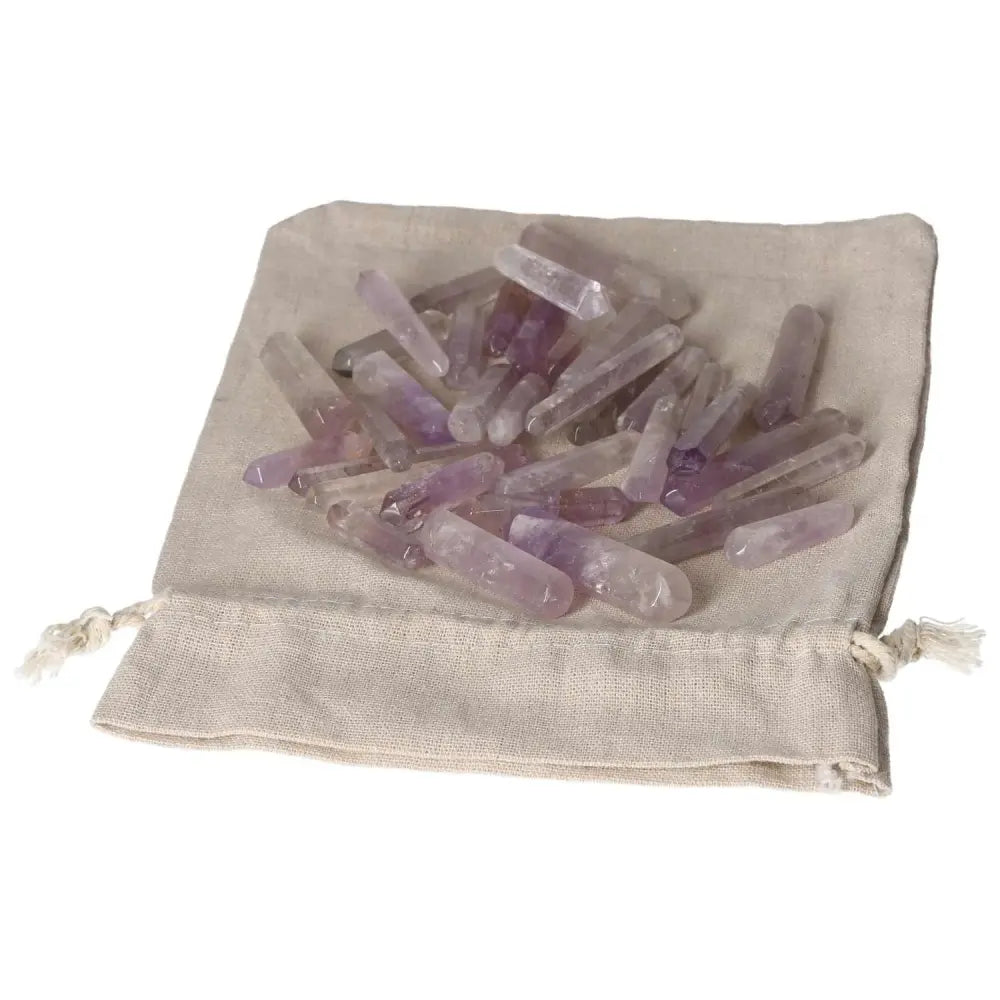 Amethyst small sticks on a cloth pouch for stress relief and energy boost, enhancing concentration and emotional stability.