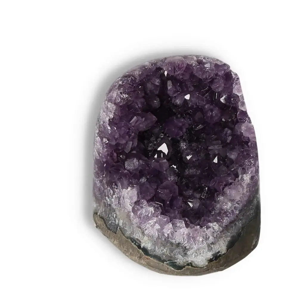 Luxurious Amethyst geode with cut base featuring deep purple crystals, known for stress reduction and concentration enhancement by Sylvia Crystals.